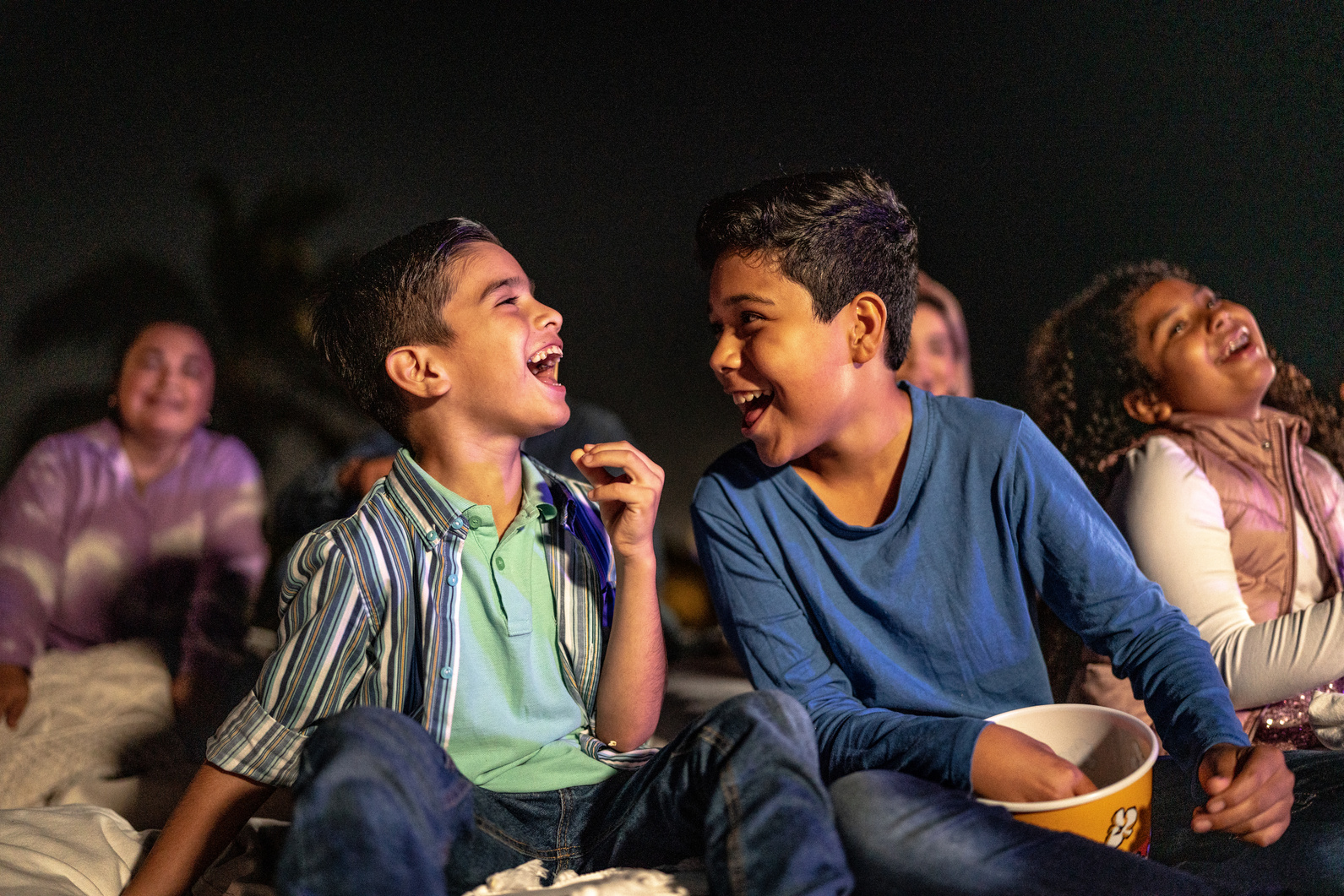 Children talking and laughing at the outdoors cinema